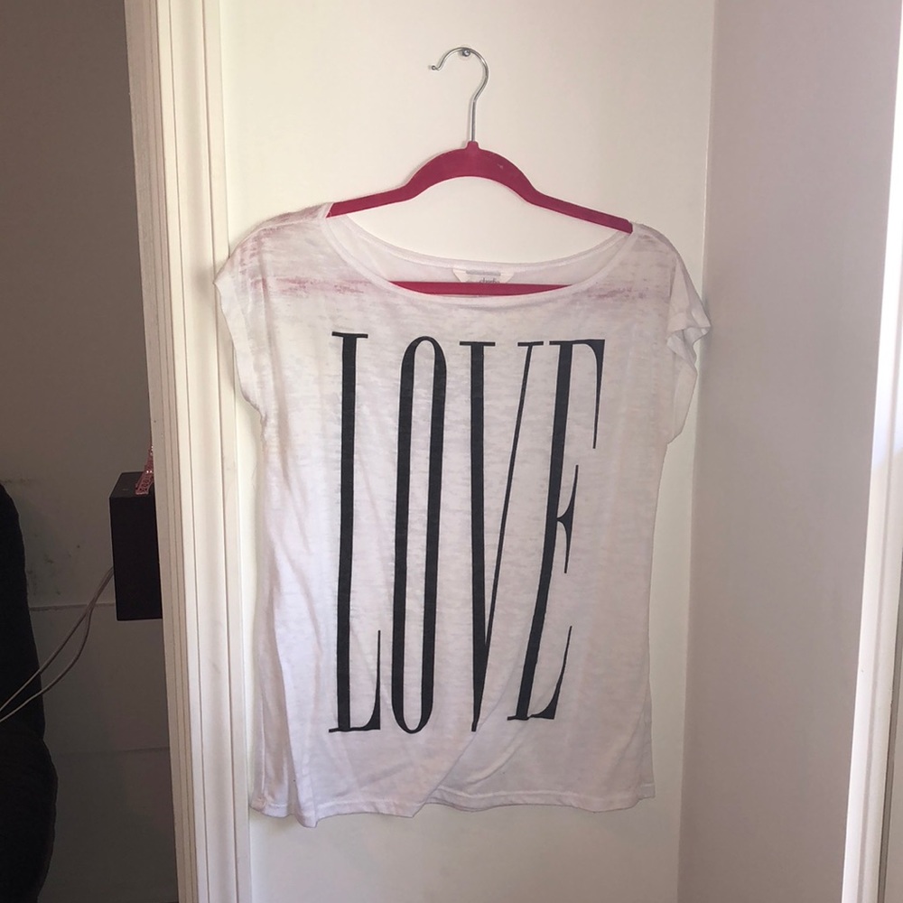 White tee with “love” in black letters